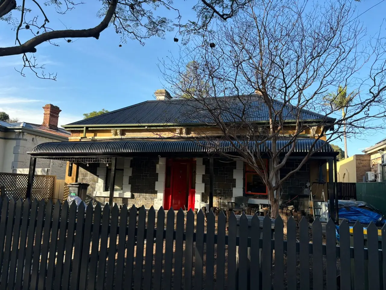 Heritage bluestone villa with new charcoal corrugated roof and veranda